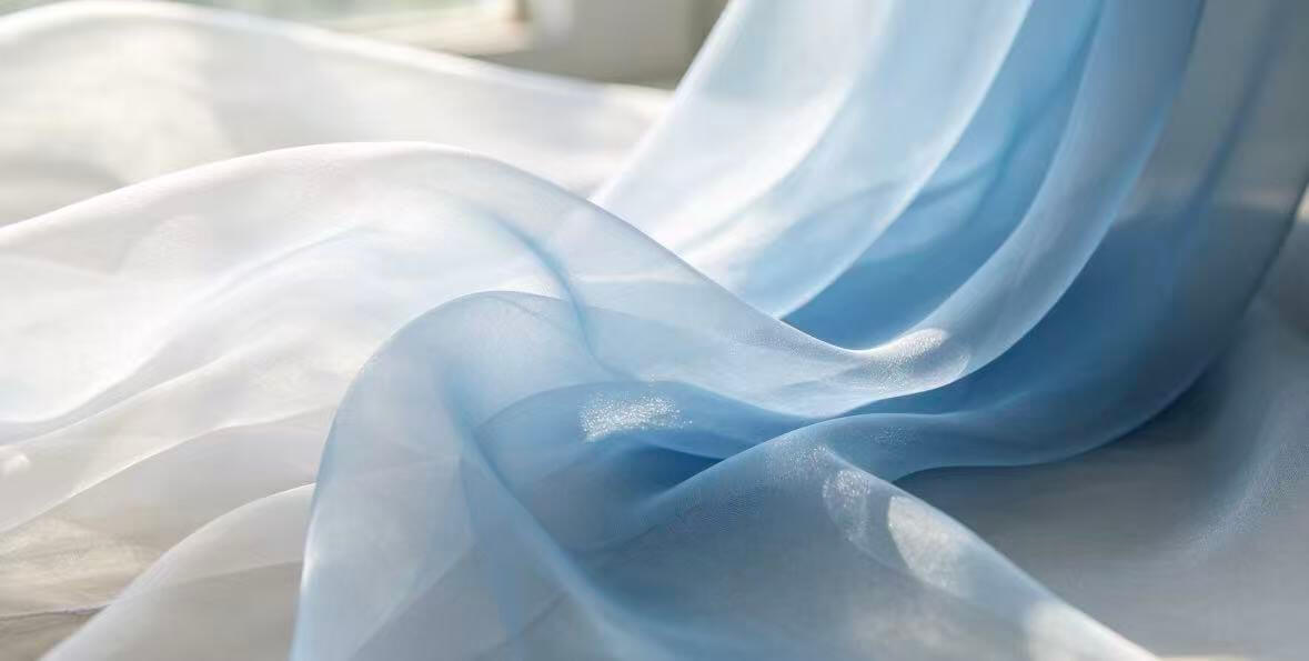 Silk fabric rolls — charmeuse, chiffon, crepe de chine, and organza displayed at a Nanchong mill