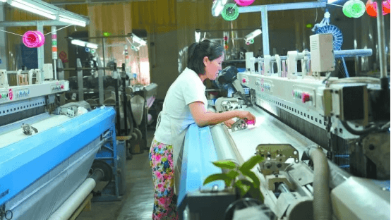 Silk weaving workshop in Nanchong, China — modern looms in full operation